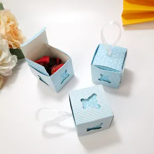 Macro detail of blue striped gift box with bear cutout and white ribbon handle