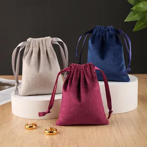 Set of velvet drawstring jewelry pouches in burgundy, navy blue and beige colors