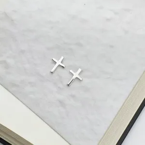 Minimalist 925 sterling silver tiny cross stud earrings with polished metallic finish