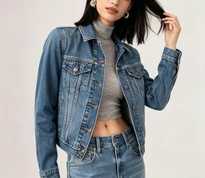Detail of vintage blue denim jacket with metallic buttons and classic chest flap pockets