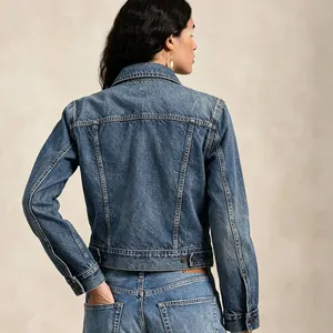 Back view of a vintage wash denim jacket with classic seams and adjustable hem button tabs