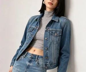 Detail of light blue washed denim jacket with metal buttons and classic chest pockets
