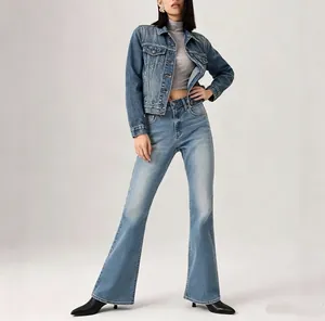 Detail of high-waist flared jeans with vintage faded texture and slim fit denim jacket