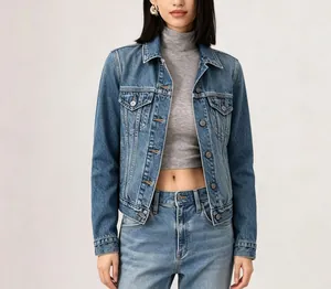 Detail of blue washed denim jacket with classic flap pockets and metallic buttons