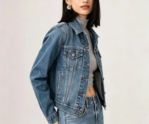 Detail view of a vintage dark blue denim jacket with flap pockets and metal buttons