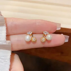 Macro shot of cherry earrings with white pearls and marquise cubic zirconia details