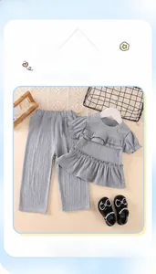 Detail of girls grey ruffle short sleeve top and wide leg pants with pleated texture