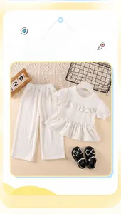 Detail view of girls white summer outfit set with ruffled sleeves and wide-leg trousers