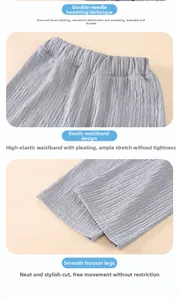 Detail view of elastic high waist and vertical pleated texture on grey wide-leg pants