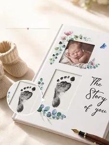 Detail of baby memory book with floral design and space for newborn photos and footprints