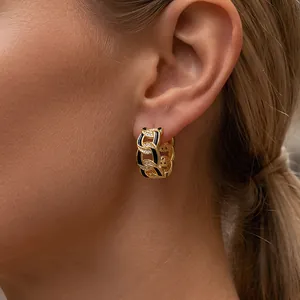 Vintage gold Cuban link hoop earrings with black enamel and zircon accents on model
