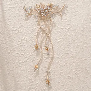 Elegant gold bridal hair comb with crystal flowers and long sparkling rhinestone tassels