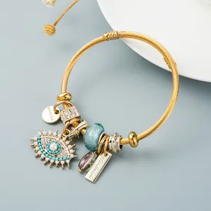Goldenes Drahtarmband mit Evil Eye Anhänger, Perlen und blauen Akzenten für Damen