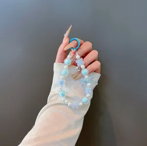 Blue beaded bow and clover keychain with pearl accents and a blue ring hook