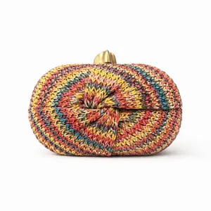 Detailed close-up of a colorful knitted clutch featuring a distinct knot design and gold clasp