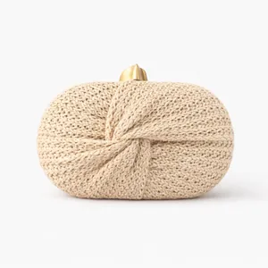 Detailed close-up of a beige woven clutch bag featuring a stylish twist knot design