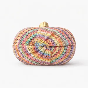 Close-up of colorful striped woven evening clutch with a golden metal clasp