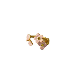 Pastel pink enamel cherry blossom open ring with gold band and yellow crystals