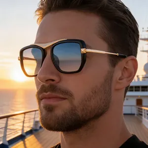 Detail of cat-eye eyewear with black frame and gold metal temples on model at sunset