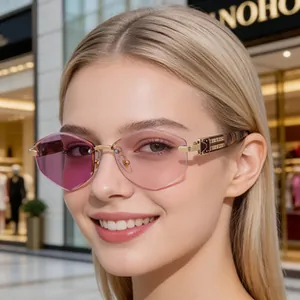 Close-up of frameless square polarized sunglasses with pink gradient lenses and gold metal hinge