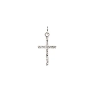 Detailed view of silver cross pendant with lava texture and tiny zircon inlay