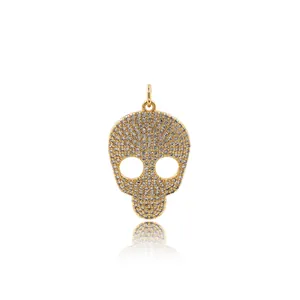 24K gold plated skull pendant with crystal pavé details and polished hanging ring
