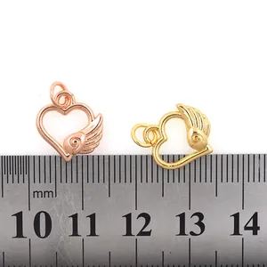 Gold plated heart pendant with angel wings and scale ruler for sizing reference