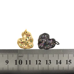 20mm gold and black heart charms with colorful zircons and lava texture on a white background