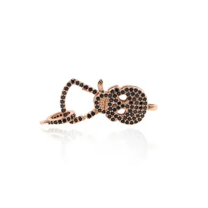 24K rose gold plated skull pendant connector with black pavé stones on white background