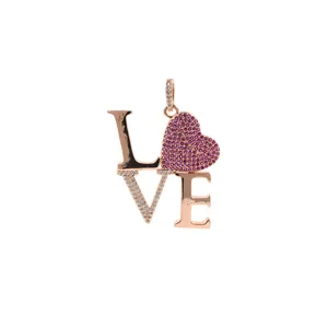 Macro detail of LOVE pendant with pink heart zircon and 24K rose gold plating