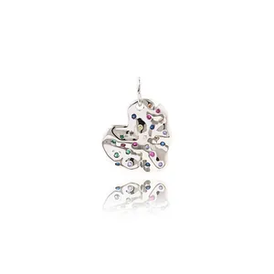 Macro view of a silver heart-shaped pendant with colorful multi-stone inlay and reflection