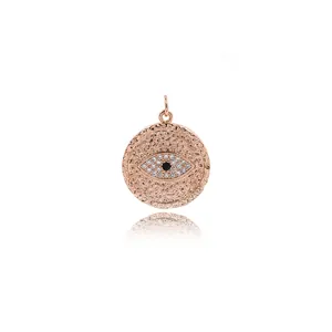 Macro shot of rose gold evil eye pendant with hammered texture and zircon crystals