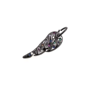 Macro detail of black wing pendant with colorful cubic zirconia in polished finish