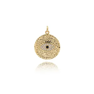 Gold plated evil eye pendant with sparkling zircons and a unique hammered metal texture