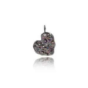 Black heart-shaped lava pendant with colorful gemstones on a white background