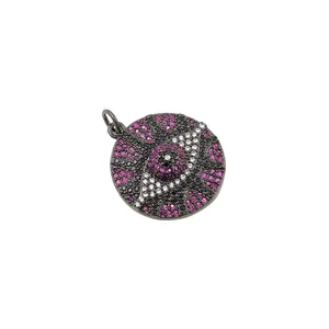 Macro view of gunmetal evil eye charm with micro-set pink and black zircon stones