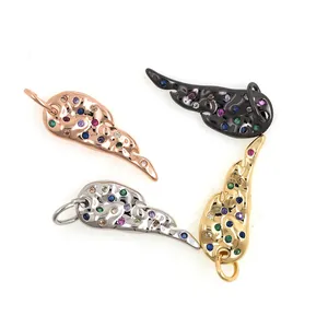 Wing pendants in four metal finishes with colorful zircon stones on white background