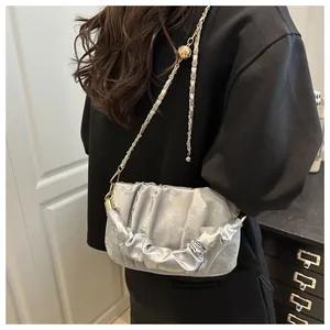 Silver pleated cloud shoulder bag with metallic chain and gold spherical detail