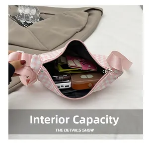 Detailed interior view of a pink plaid dumpling bag showing large storage capacity