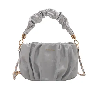 Silver pleated cloud handbag with gold chain strap and scrunched handle for women