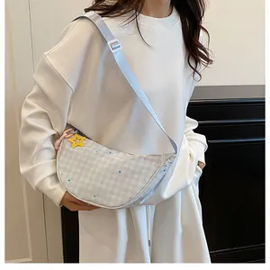 Detail of light blue checkered crescent bag with star pattern and yellow star charm