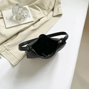 Top view of spacious black pebble leather bag interior with gold-tone zipper details