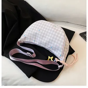 Detail of plaid dumpling bag with star patterns, metal zipper and yellow star charm