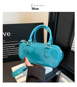 Close-up of blue jelly PVC pillow bag with high-gloss finish and gold hardware accents