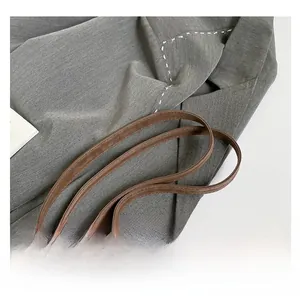 Detail shot of the durable dark brown leather shoulder straps with fine stitching craft