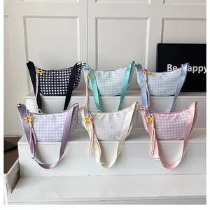 Detail view showing six pastel checkered croissant bags with star-shaped charms
