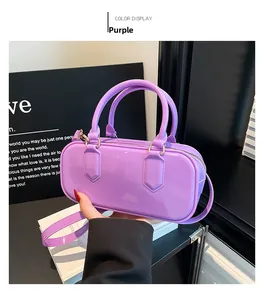 Detail of glossy purple PVC jelly bag showing golden hardware and detachable strap