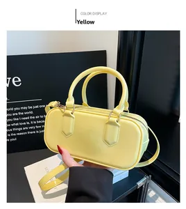 Detailed shot of a bright yellow glossy PVC jelly bag with gold hardware and dual handles