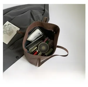 Macro view of leopard print tote bag interior showing large storage capacity and items
