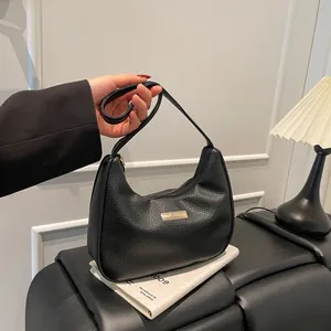 Chic black lychee leather crescent shoulder bag with golden hardware for daily use